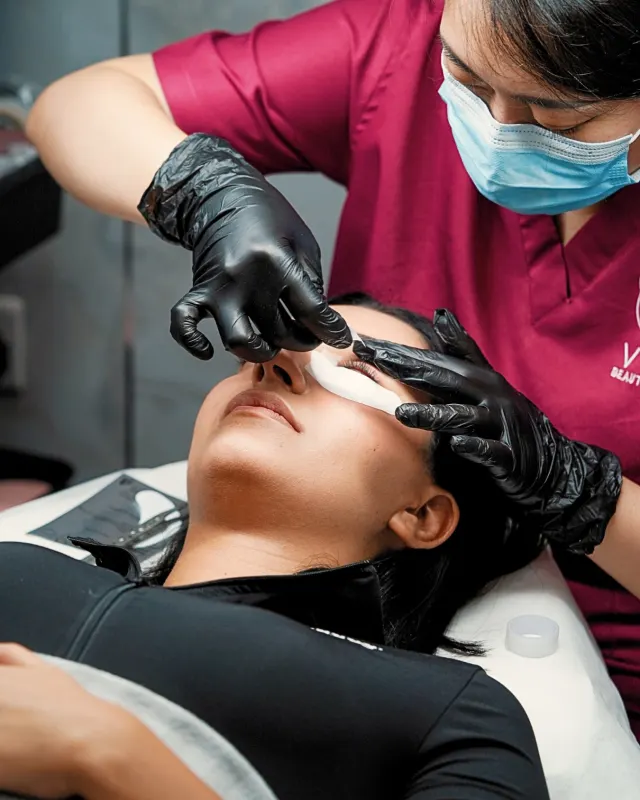 Therapist giving a facial treatment at VOG Beauty Salon