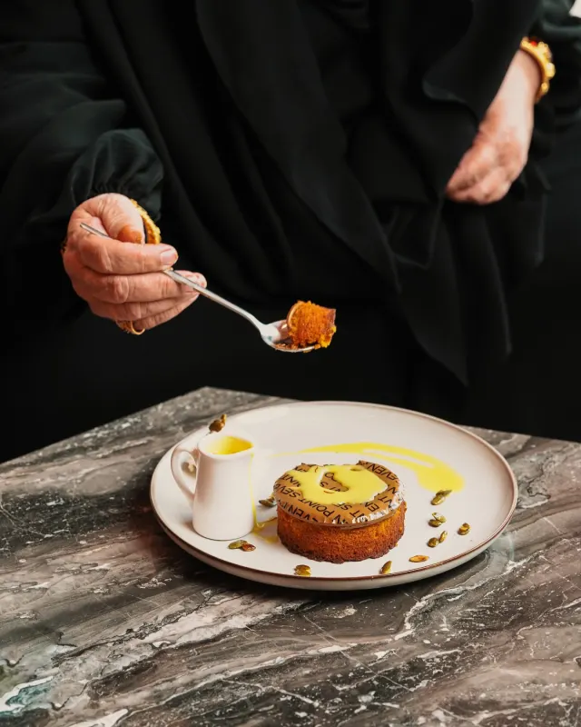 Spoonful of aseeda dessert at the table, food photography for Point Seven Coffee