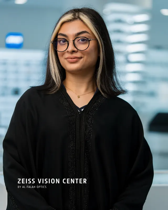 Portrait of a woman in glasses and an abaya inside ZEISS Vision Center