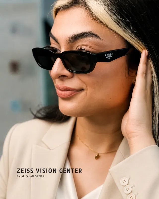 Woman trying on designer sunglasses, eyewear portrait for ZEISS Vision Center